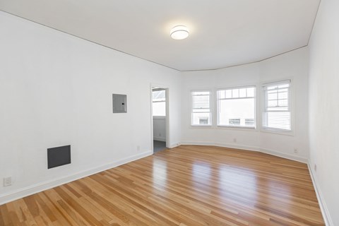 A room with wooden floors and a white ceiling.