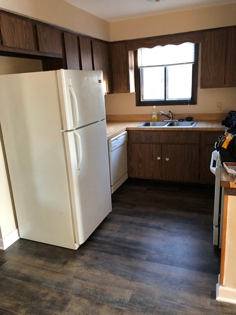 a kitchen with a refrigerator and a sink