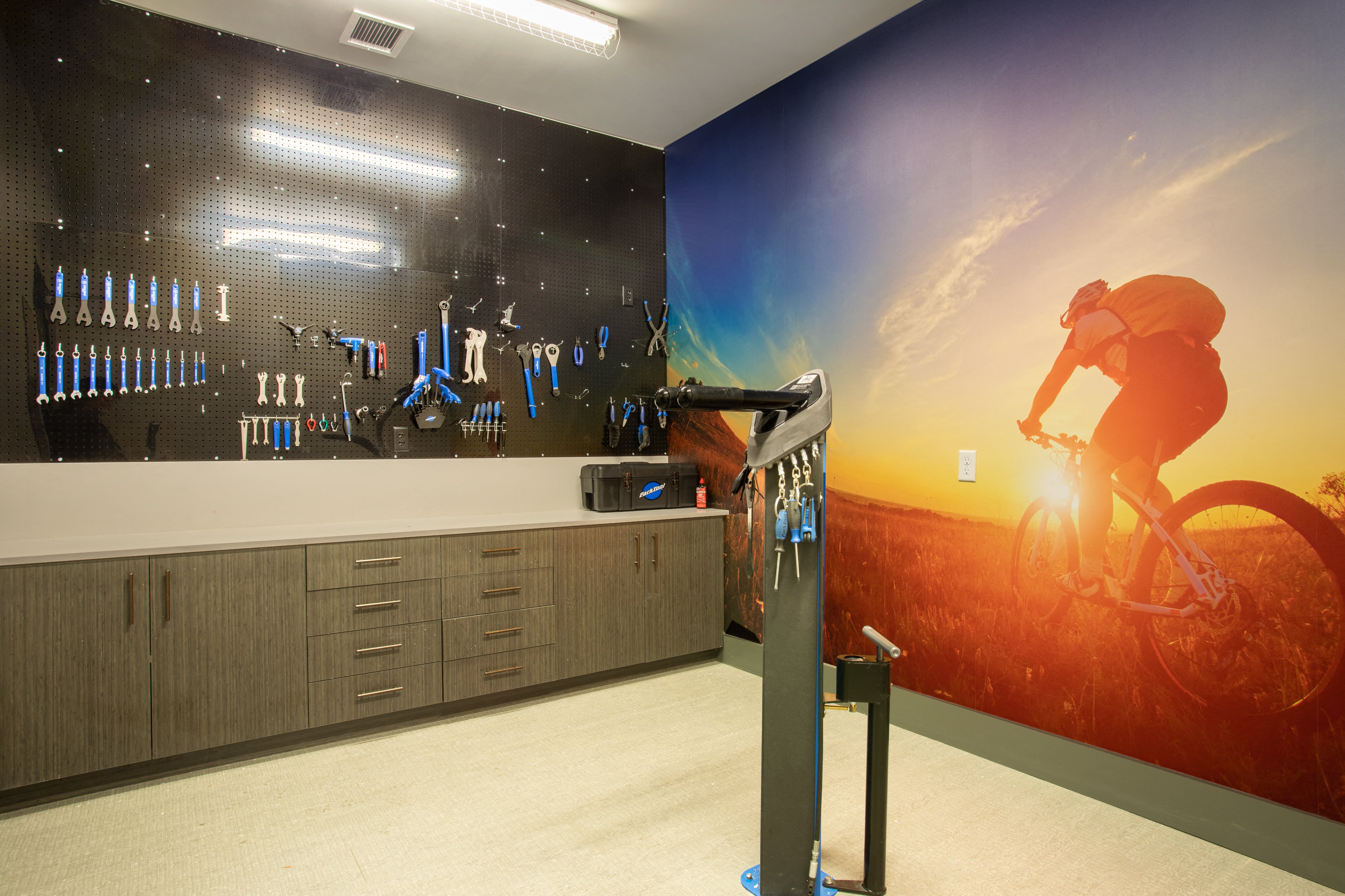 a room with a wall mural of a person riding a bike