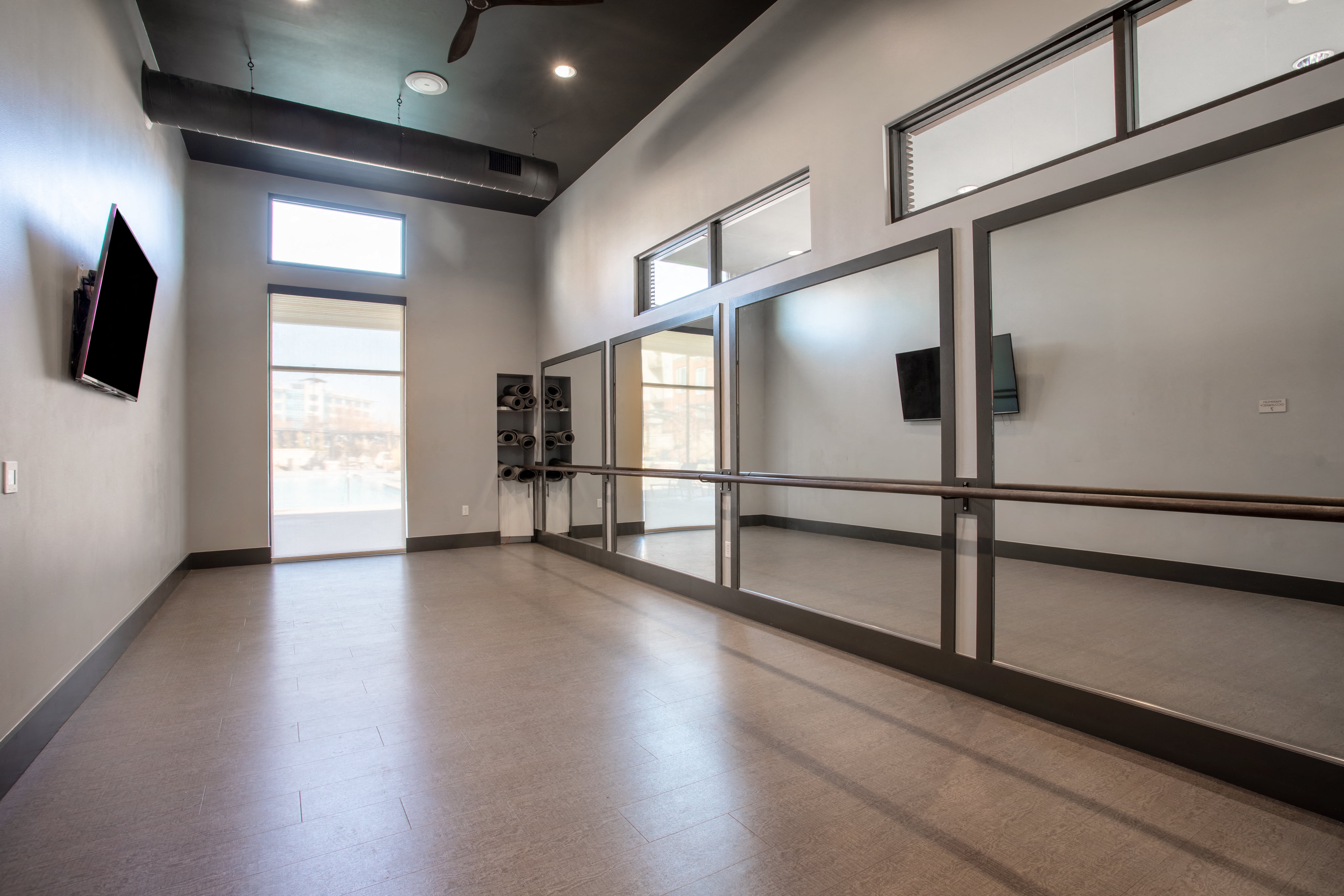 a large empty room with a window and a door