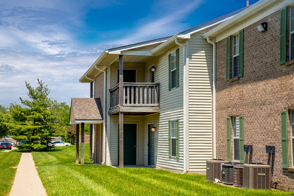 an apartment building with a balcony and a walkway