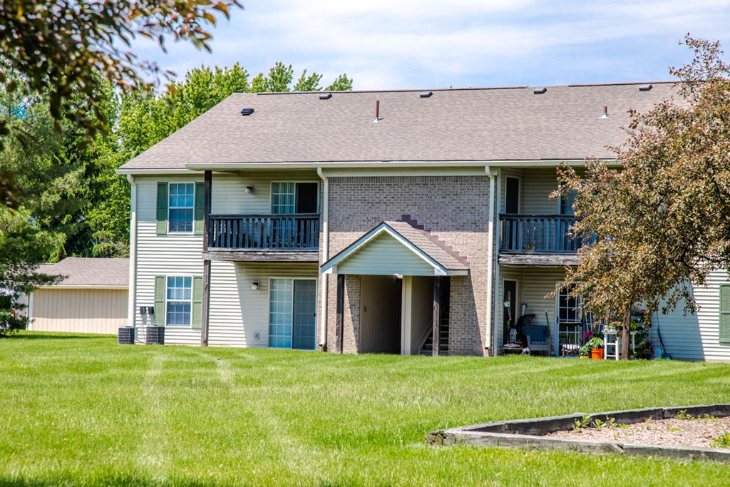 a white house with a yard in front of it