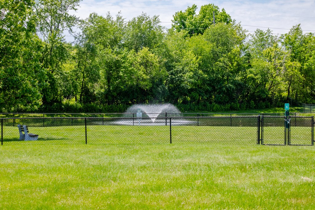 a sprinkler spraying water on a tennis court