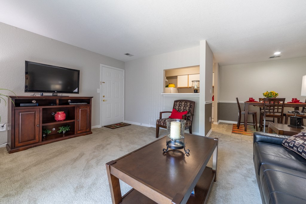 a living room with a couch and a coffee table and a television