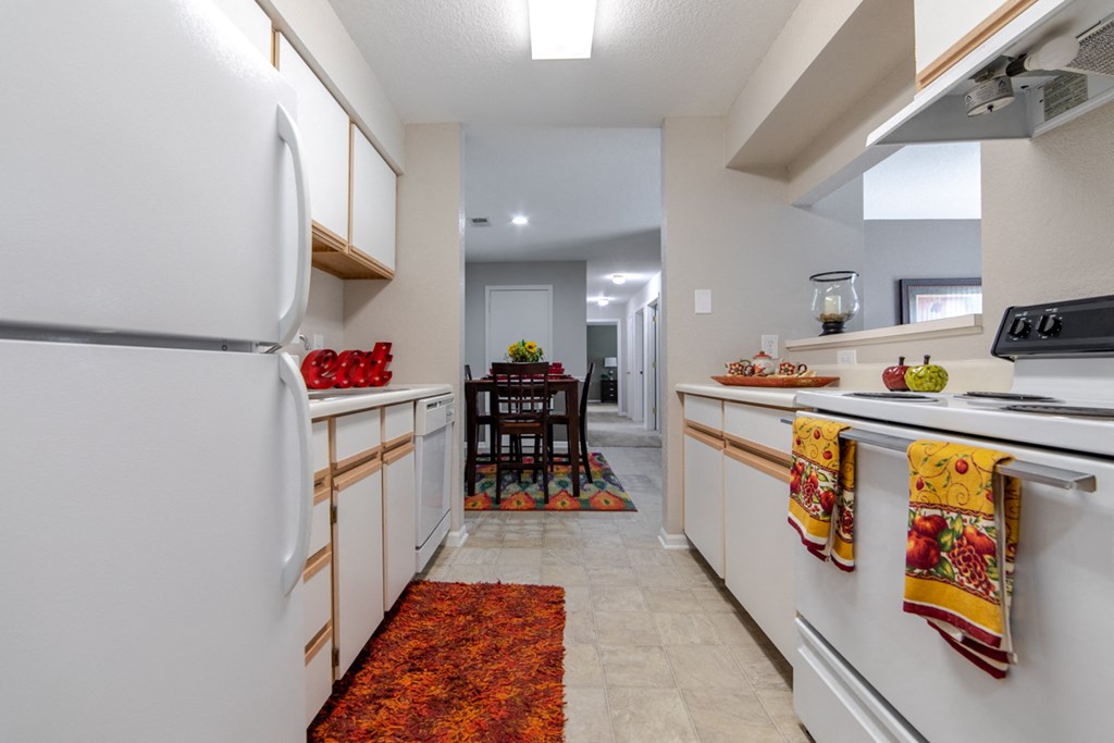 a kitchen with white cabinets and white appliances and a white refrigerator