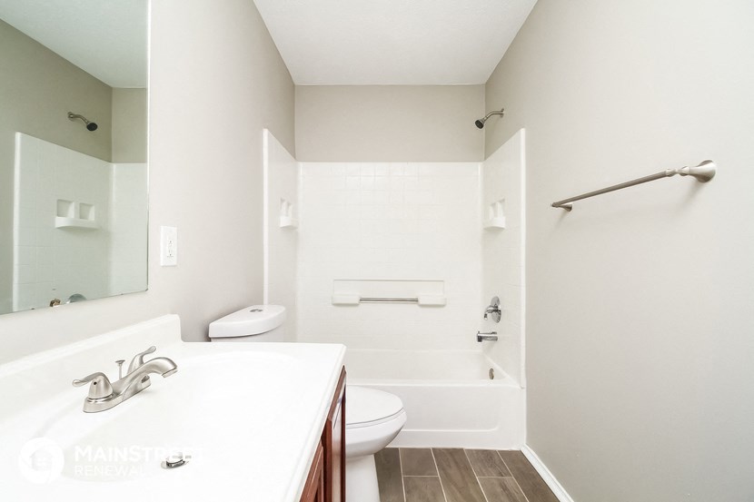 a bathroom with a sink and a toilet and a bath tub