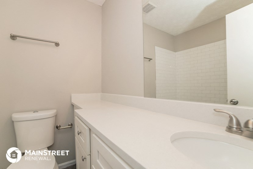 a bathroom with a sink and a mirror and a toilet
