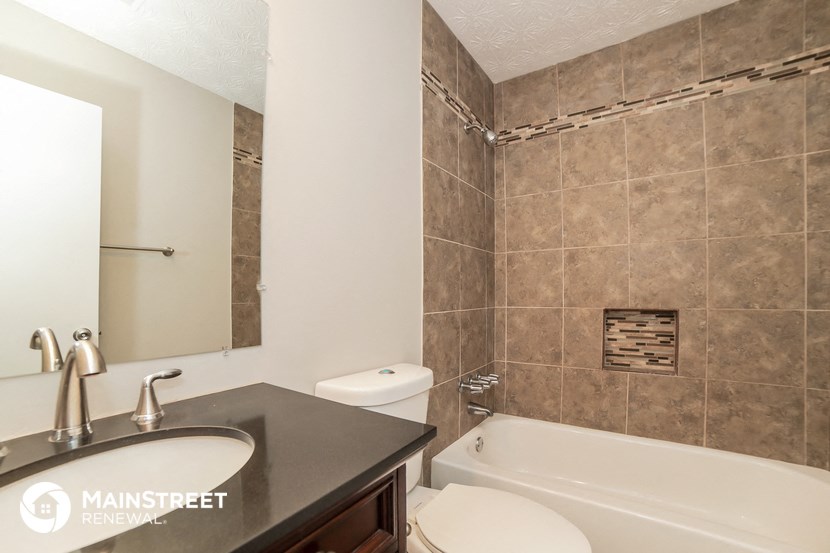 a bathroom with a sink and a toilet and a bath tub