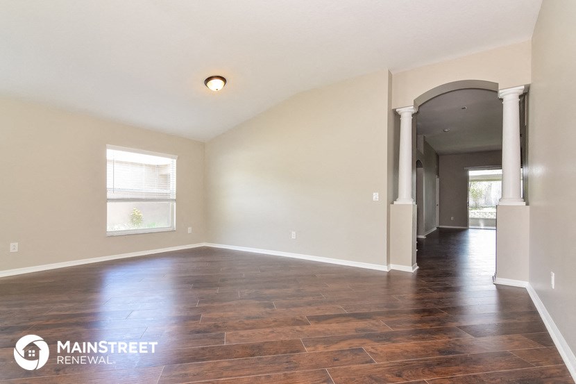 the living room and dining room with hardwood flooring