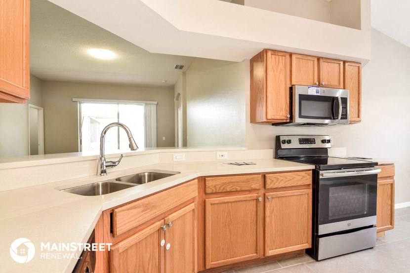 a kitchen with wooden cabinets and a sink