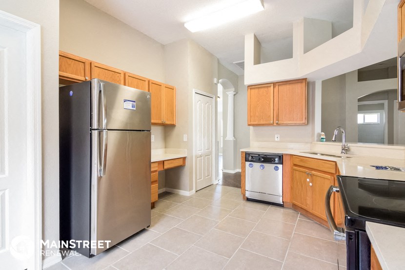 a kitchen with stainless steel appliances and wooden cabinets