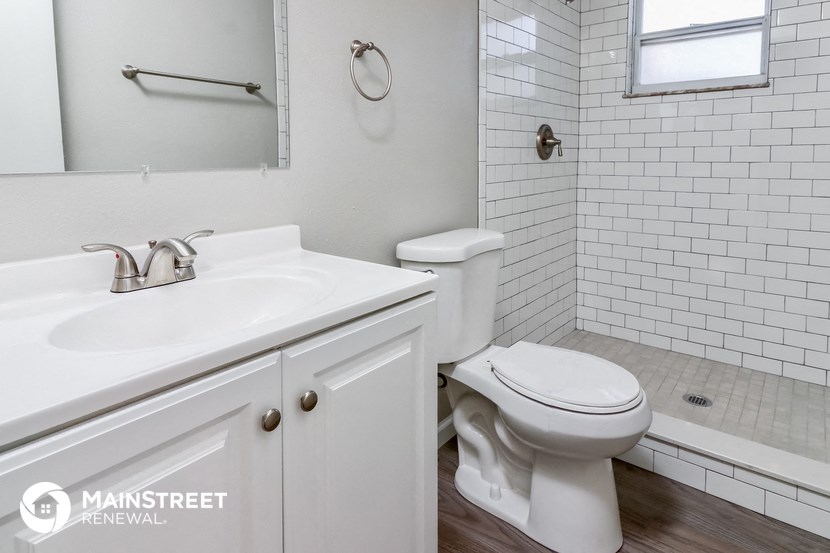 a white bathroom with a sink and a toilet