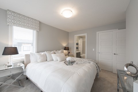 a bedroom with a large white bed and a closet