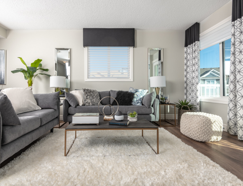 a living room with a gray couch and a coffee table