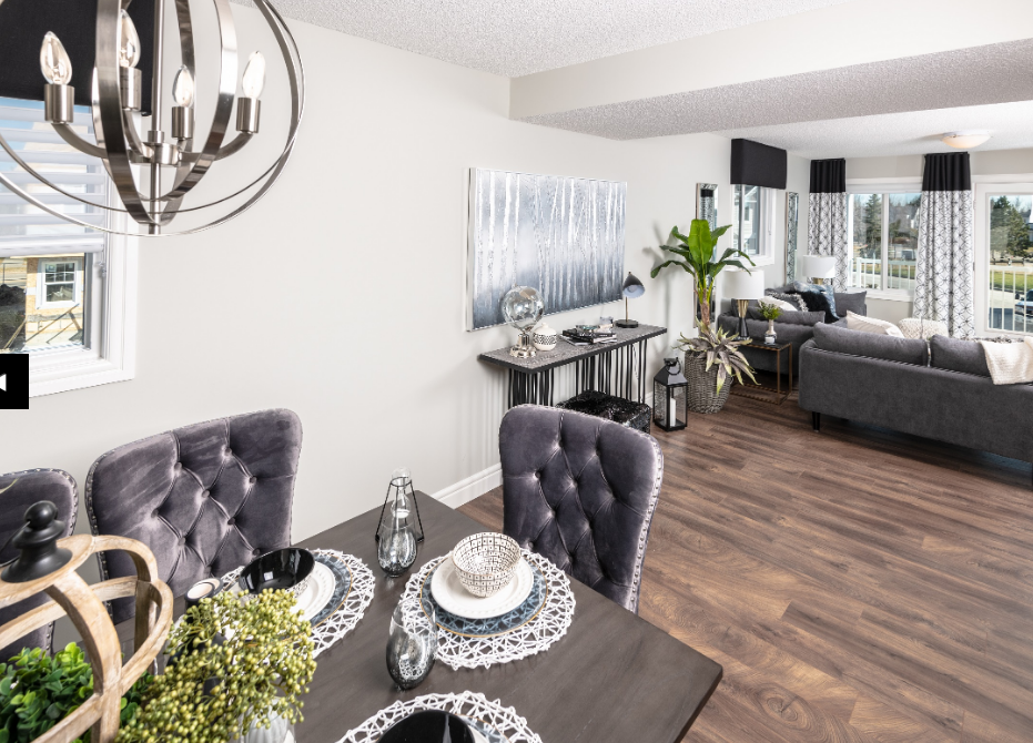 a living room and dining room with a table and chairs