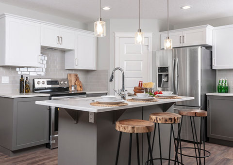 a kitchen with a center island and three stools