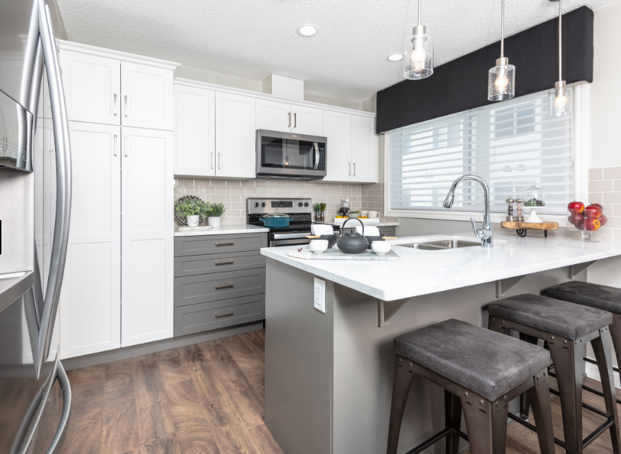 a kitchen with white cabinets and a white counter top