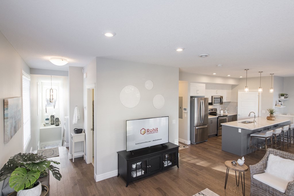 a living room with a television and a kitchen