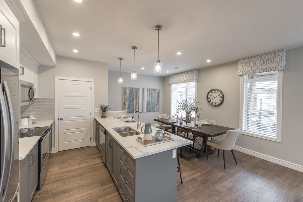 an open kitchen and dining room with a table and chairs