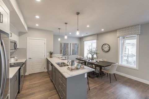 an open kitchen and dining room with a table and chairs