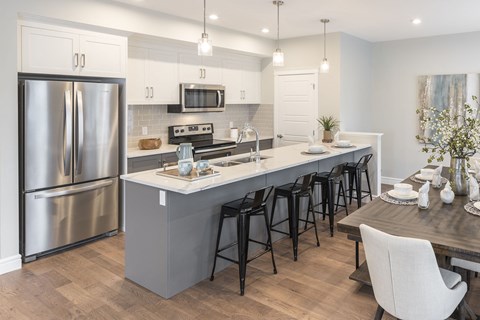 a kitchen with a large island and stainless steel appliances