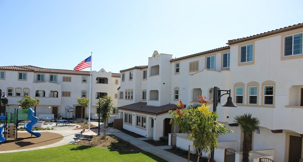 an flag flies over the courtyard of an apartment building