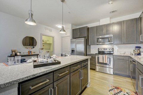 a kitchen with stainless steel appliances and granite counter tops