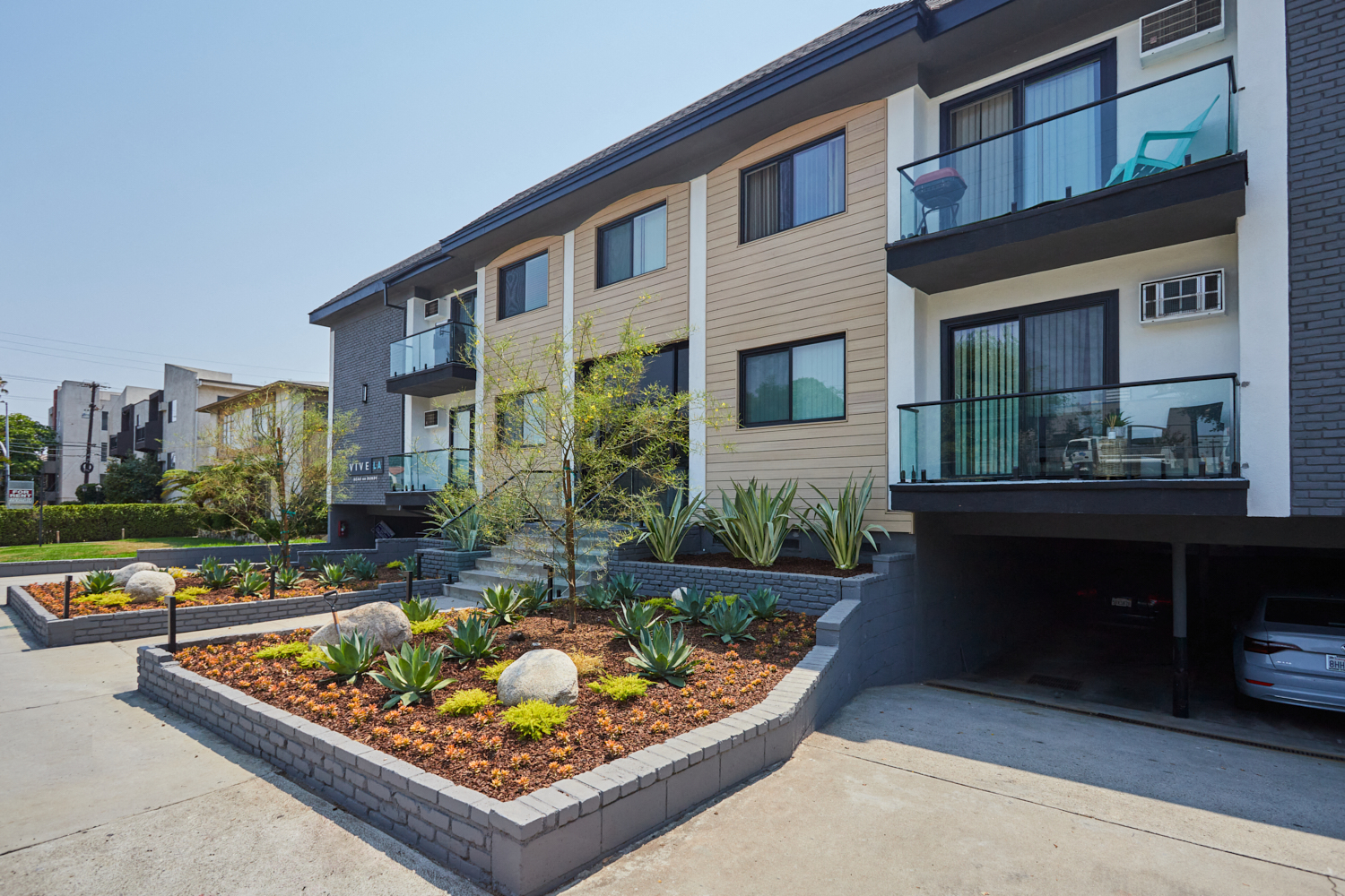 Exterior showing large balconies and plants surrounding building