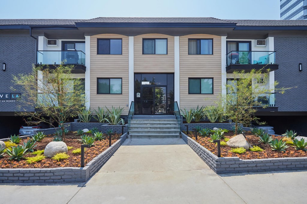 Path to front door bracketed by small plant gardens