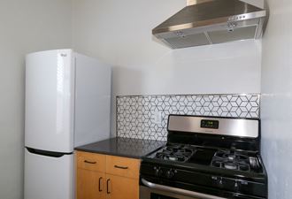 Unit Kitchen with Brand New Kitchen Appliances and Modern Backsplash