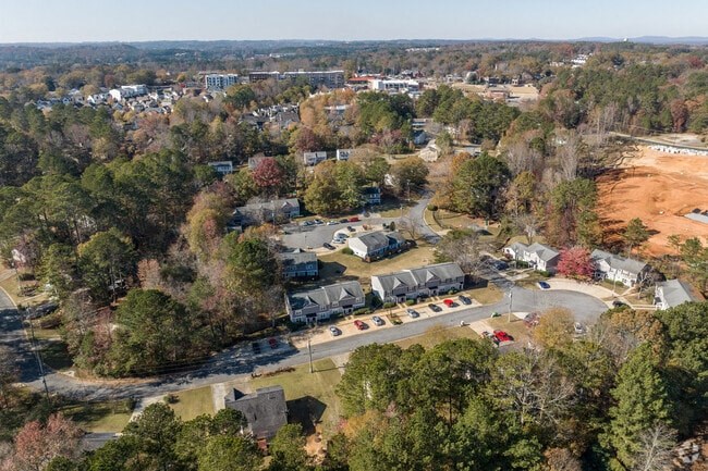 A bird's eye view of a residential area with houses and trees.
