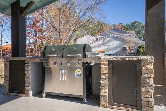 A stainless steel oven with a stone surround is in the foreground.