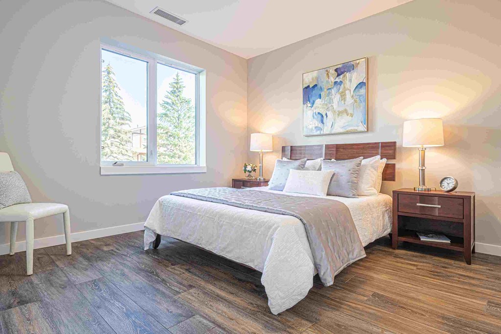 a bedroom with a bed and a window