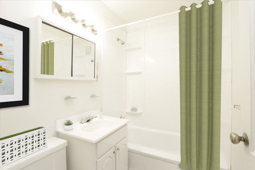 a white bathroom with a green shower curtain