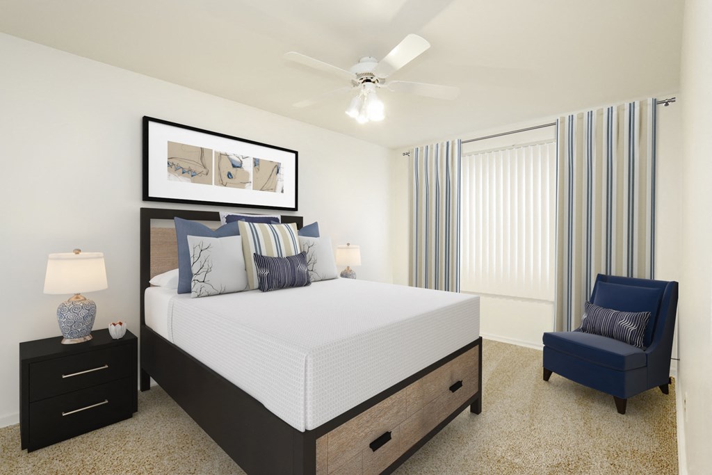 a bedroom with a large bed and a ceiling fan