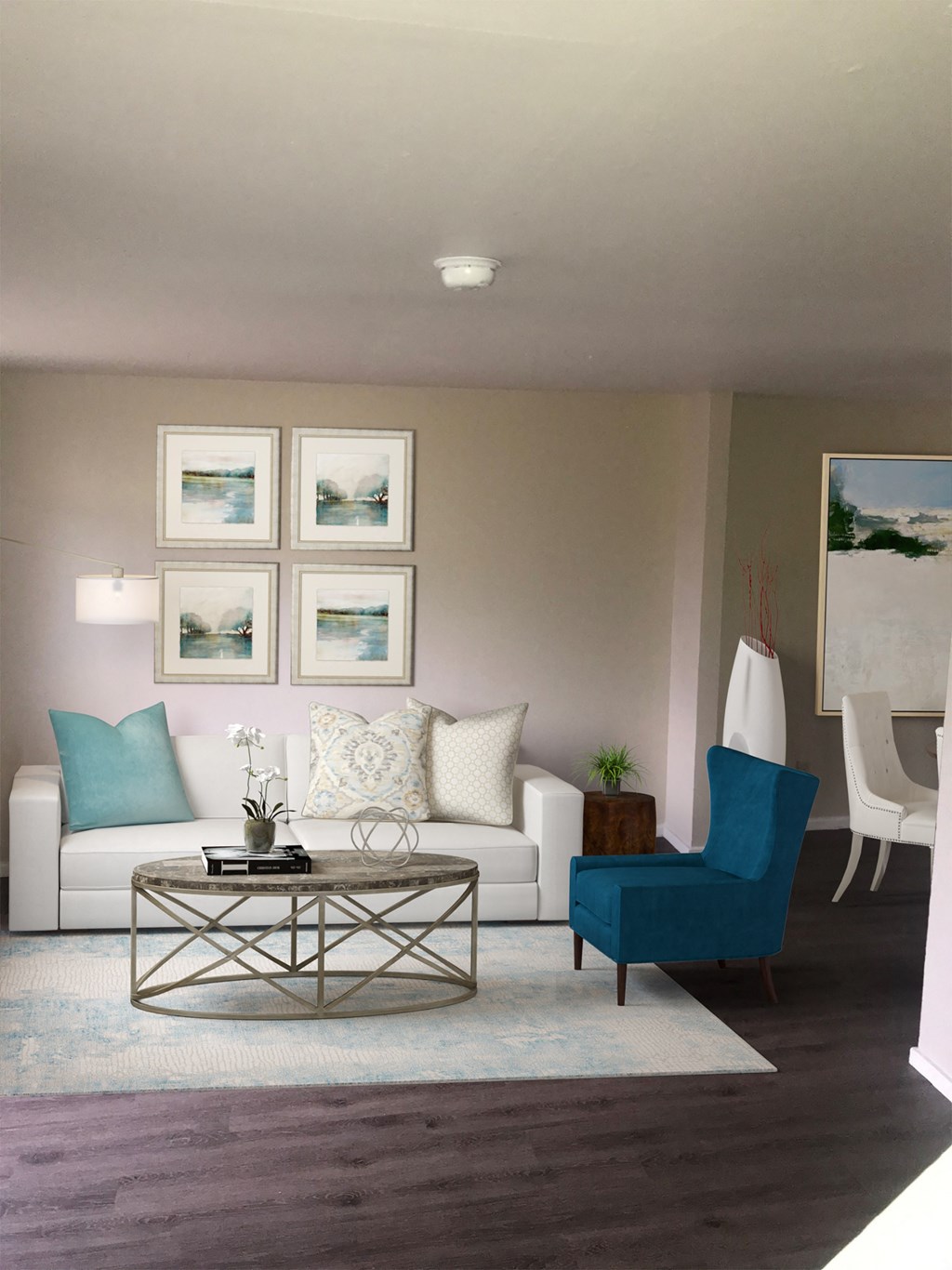 a living room with a white couch and a blue chair