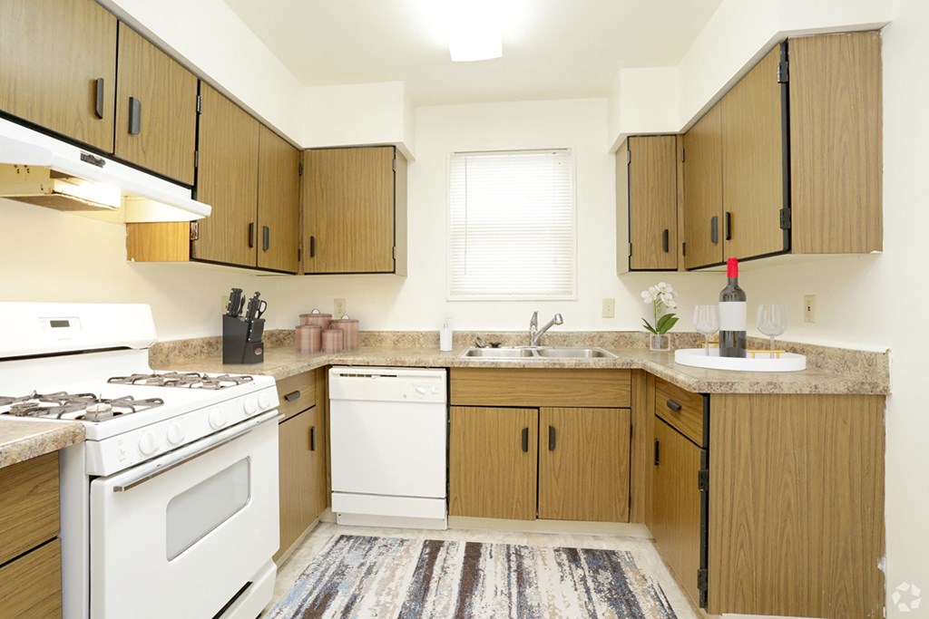 a kitchen with white appliances and wooden cabinets