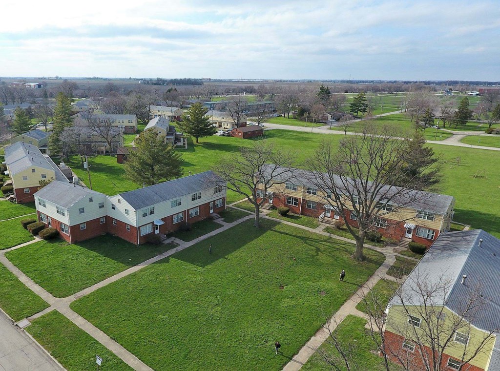 an aerial view of a neighborhood with houses and green grass