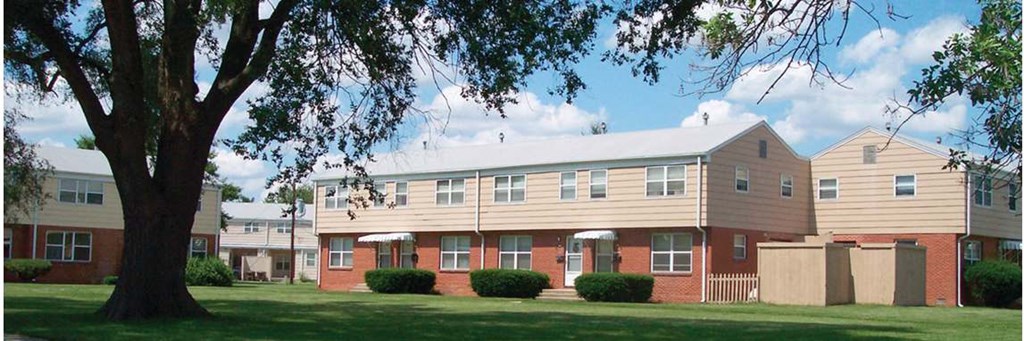 a large building with a tree in front of it