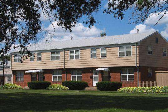 a red brick house with a wood exterior