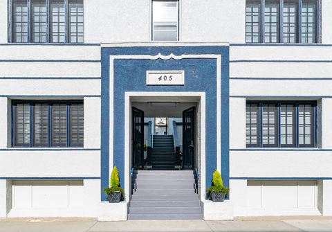 the front of a blue and white building with stairs