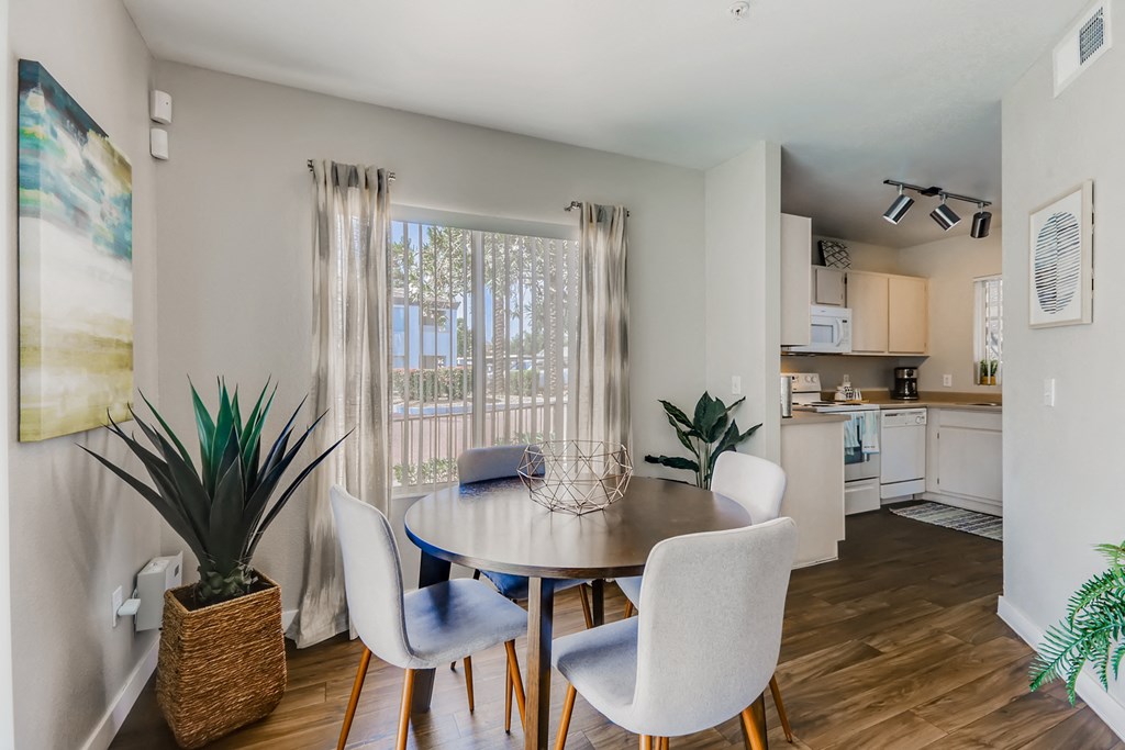 a dining room with a table and chairs and a kitchen