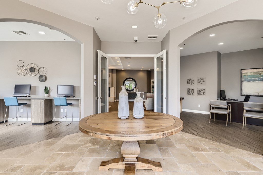 a formal living room with a large table and a dining room
