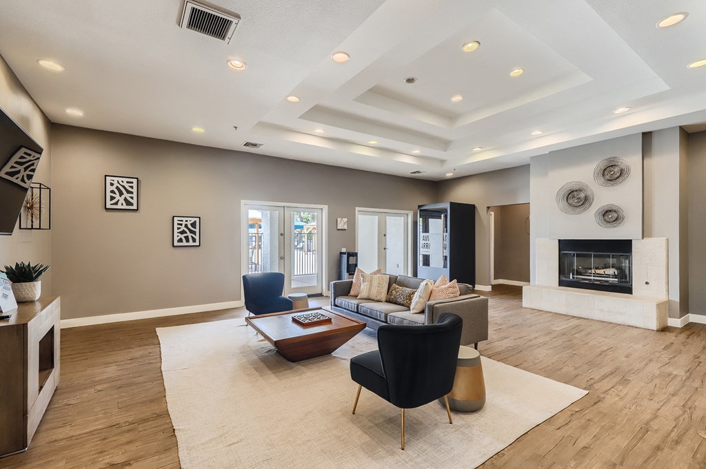 a living room with a couch and chairs and a fireplace