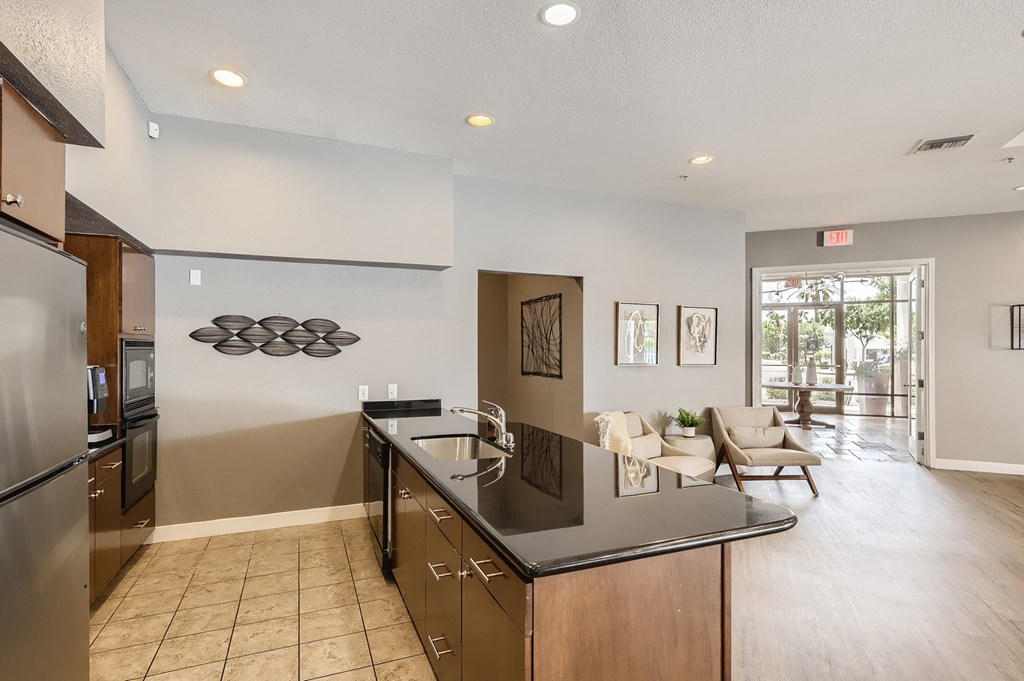 the kitchen is open to the living room and equipped with stainless steel appliances