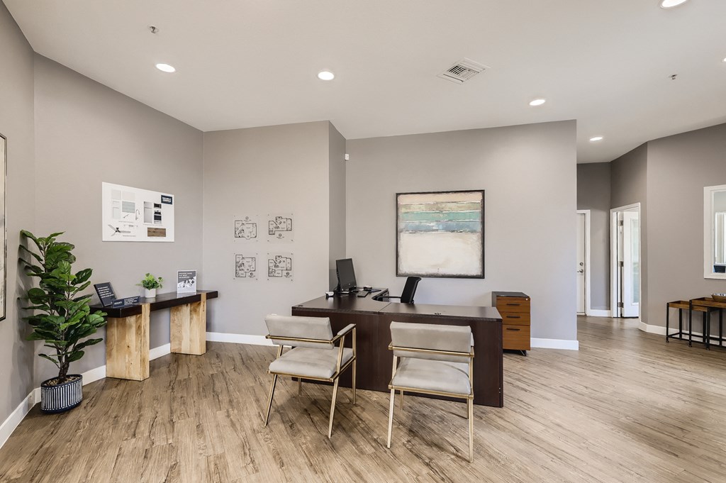 an office with a wooden floor and a desk with two chairs