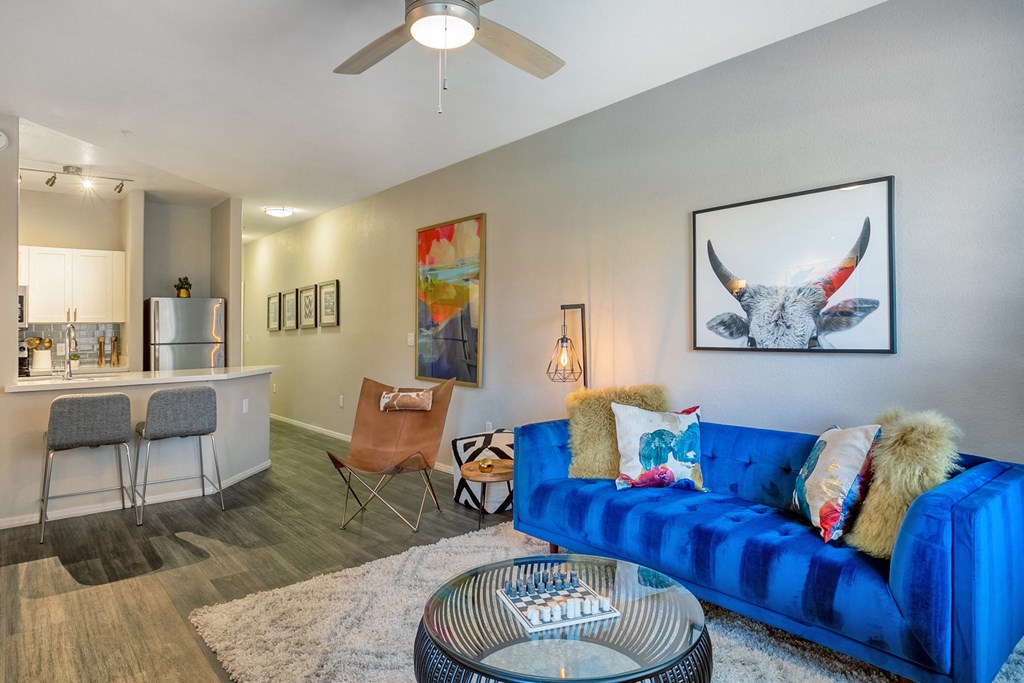 a living room with a blue couch and a table