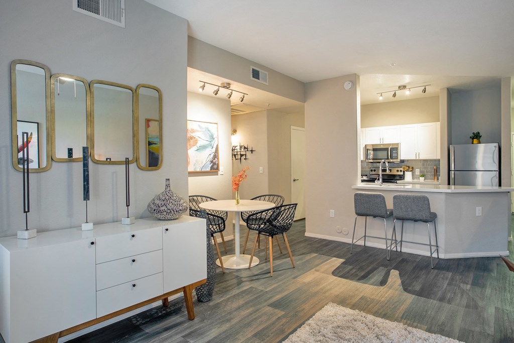 a living room with a dining area and a kitchen