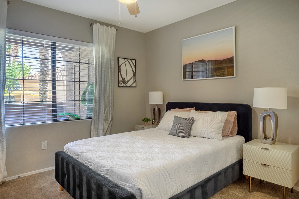 a bedroom with a large bed and a window