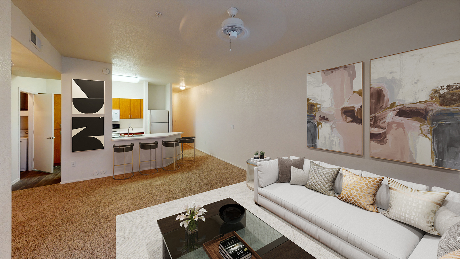 a living room with a white couch and a glass table